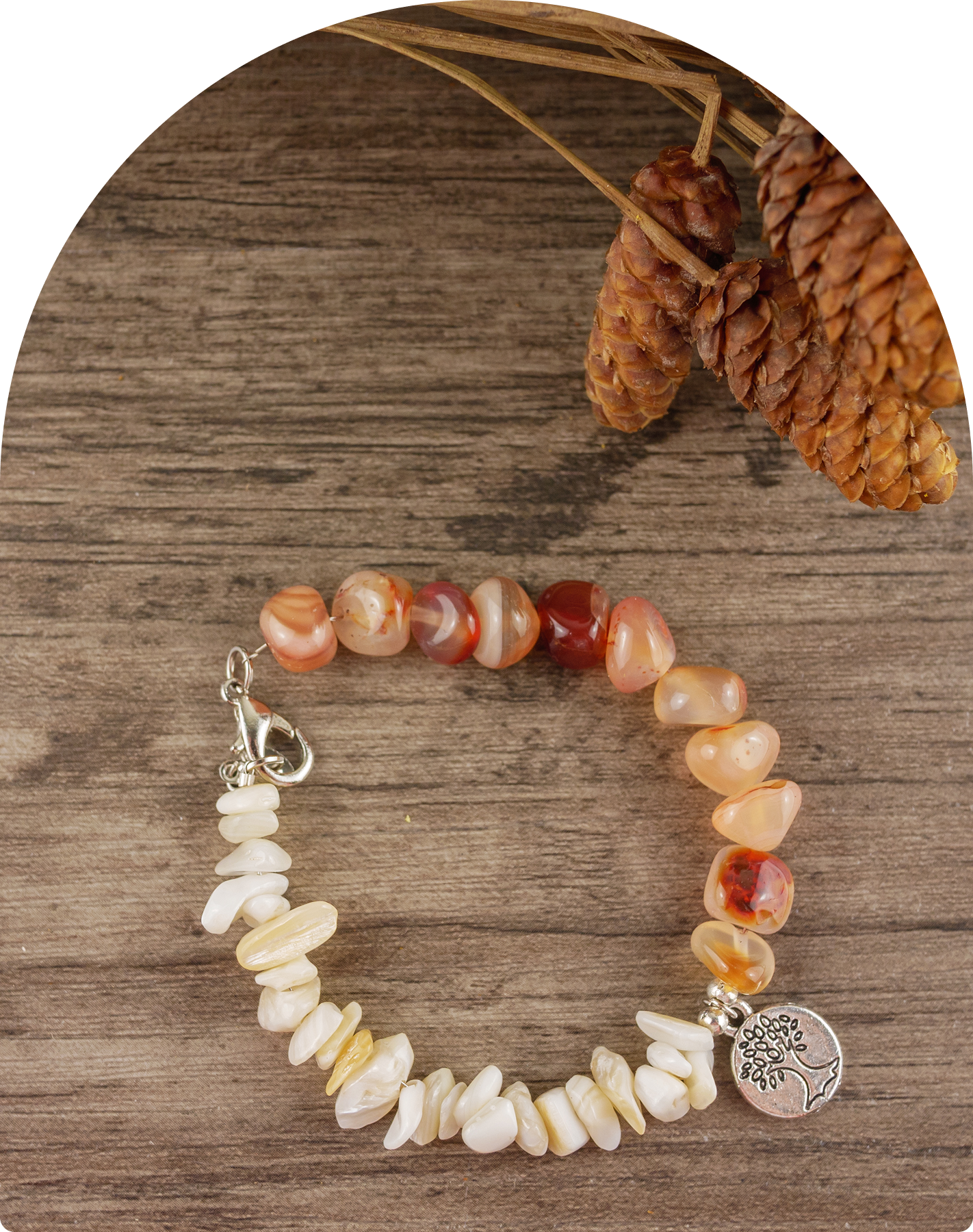 Beaded bracelet with charm on wooden surface.