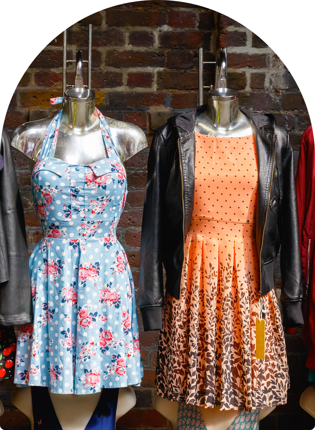 Mannequins wearing floral and polka dot dresses.